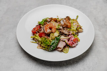 Salad with seafood on a gray background. View from above.
