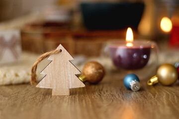 Various Christmas decorations, cup of tea or coffee, sweets, small presents, knitted blanket and candles. Selective focus.