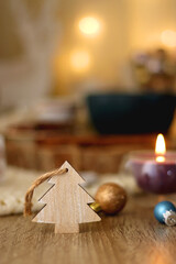 Various Christmas decorations, cup of tea or coffee, sweets, small presents, knitted blanket and candles. Selective focus.
