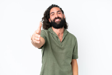 Young man with beard over isolated white background shaking hands for closing a good deal