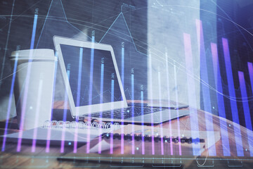 Stock market graph on background with desk and personal computer. Double exposure. Concept of financial analysis.