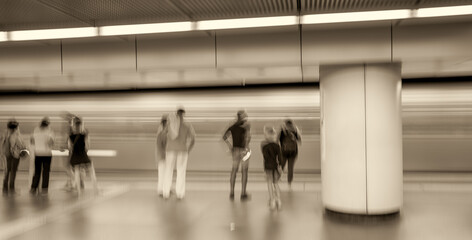 Blurred movement of people inside a subway station. Business and travel concept