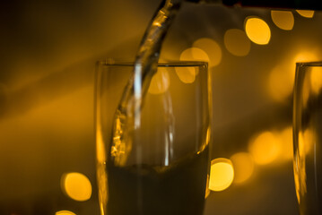 Den Helder, netherlands. December 2022. A glass of champagne on a goloden background.