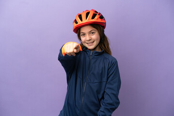 Little caucasian girl isolated on purple background pointing front with happy expression