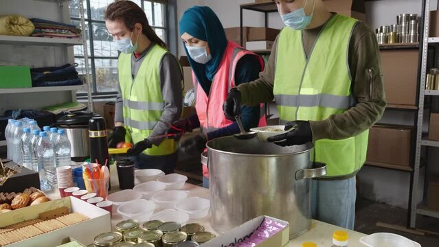 Refugee Community Kitchen serves hot, nourishing meals to displaced people. Multinational volunteers distribute hot lunches to the needy and refugees.