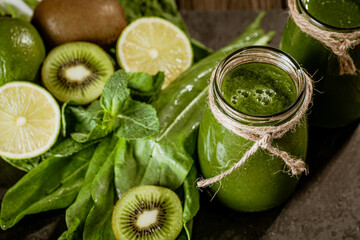 Naklejka na ściany i meble Closeup of fresh green smoothie in glass jars with lime. Detox concept. Good food