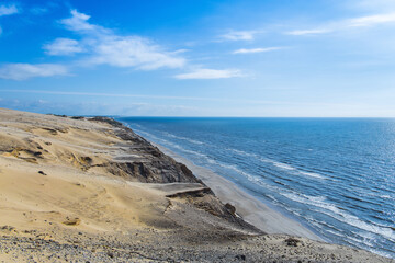 The iconic coast line in Denmark with rocks, sand dunes and the ocean