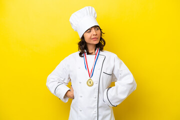 Young chef latin woman isolated on yellow background