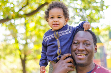 Happy mixed race family, happy dad holding his beautiful baby girl