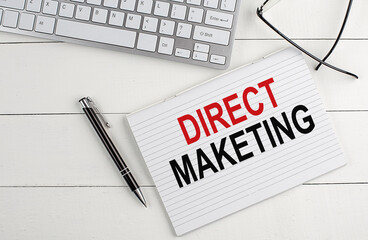 text DIRECT MARKETING on a keyboard on white background