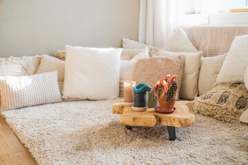 Bohemian style interior with beautiful light colours like beige and off-white and a lot of pillows