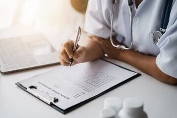 Doctor working to write a patient report in the clinic.