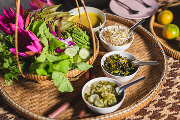 Thai food and culture concept, vegetables and curry, savory dishes, in woven wooden tray.