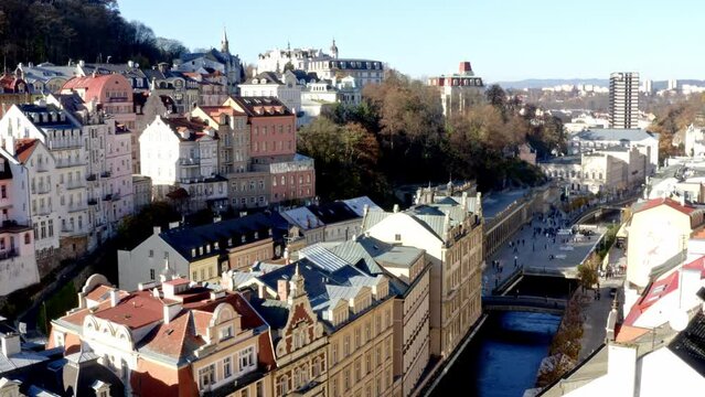 Karlovy Vary spa town with pretty houses and Tepl&aacute; river in sunlight.