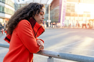 Outdoor portrait of an upset woman using a mobile phone visiting a Europe city
