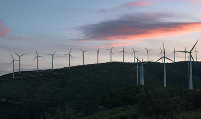 Wind turbines with some clouds in the sky at sunset. Renewable energy