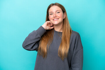 Fototapeta premium Young caucasian woman isolated on blue background laughing
