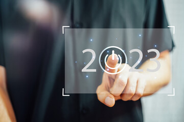welcome year 2023. New year 2022 change to 2023 concept, businessman hand touching on 2023 virtual...