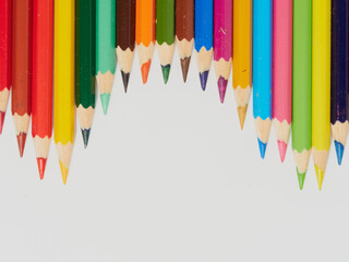 Colored pencils isolated on a white background. Close it.