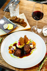 Deer tenderloin. Truffle-potato puree, porcini mushrooms, baked leek and carrot, juniper bread, port wine sauce. Delicious healthy traditional food served for lunch in modern gourmet restaurant