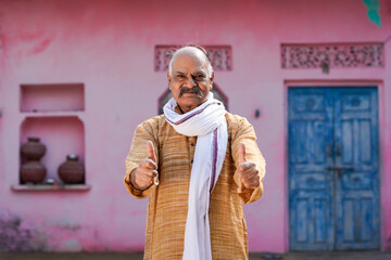 Indian old man showing thumps up