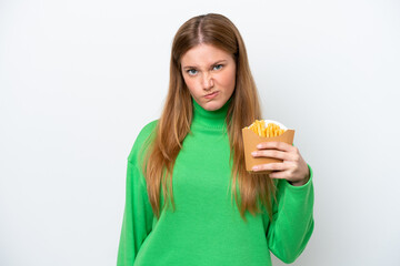 Young caucasian woman holding fried chips isolated on white background with sad expression