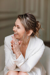 an attractive, happy and confident woman in a white suit. 