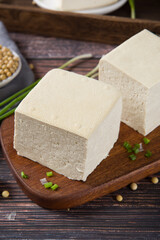 Block of fresh Tofu on wooden background