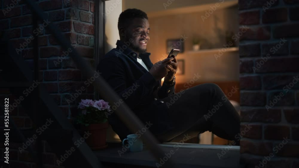 Poster happy black man using smartphone to browse funny online content or chat with friends on social media