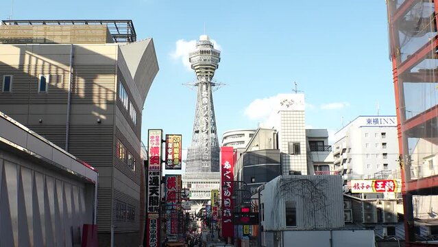 OSAKA, JAPAN - OCT 2022 : Time lapse shot of SHINSEKAI area in daytime. This area is known for &ldquo;kushikatus (Deep fried meat and vegetables)&rdquo; restaurants. Osaka travel concept video.