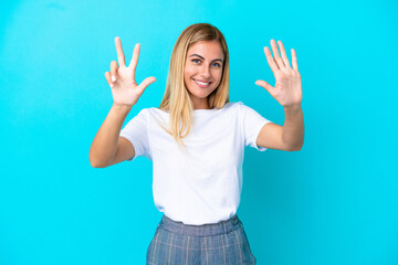 Blonde Uruguayan girl isolated on blue background counting eight with fingers