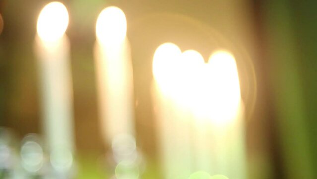 Hanukkah candles in candelabra menorah, blurred with bokeh. Jewish holiday symbol celebration.Holiday lights
