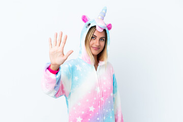 Blonde Uruguayan girl wearing a unicorn pajama isolated on white background counting five with fingers
