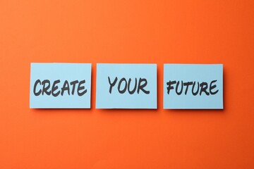 Motivational phrase Create Your Future made of sticky notes with words on orange background