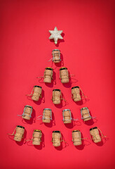 Silhouette of Christmas tree made from champagne corks on red background. Merry Christmas and Happy New Year concept