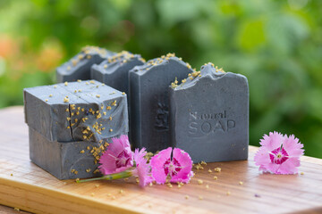  Dark blue handmade soap with pink flowers on a green background