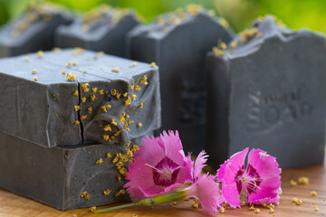  Dark blue handmade soap with pink flowers on a green background