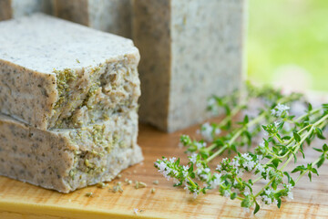 Green handmade scrub soap closeup with wormwood and thyme.