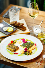 Pike-perch fillet. Potato gratin, warm yellow beet-turkey bean salad, parmesan dressing. Delicious seafood fish closeup served on a table for lunch in modern cuisine gourmet restaurant