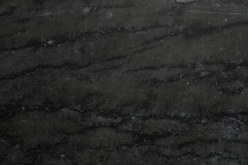 Black marble surface as background, closeup view