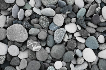 Many different pebbles as background, top view