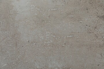 Texture of light grey stone surface as background, closeup