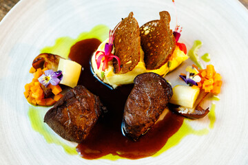 Deer tenderloin. Truffle-potato puree, porcini mushrooms, baked leek and carrot, juniper bread, port wine sauce. Delicious healthy traditional food served for lunch in modern gourmet restaurant