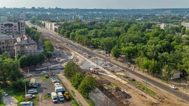 Panoramic aerial view of road big construction site timelapse. Concrete works and installing plates for rails comfort system. Reconstruction of tram tracks