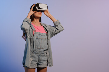 VR virtual reality glasses on a girl. Looks to the future. Touching the new. Fantastic virtual...