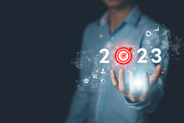 2023 Success business concept with Businessman hand hold virtual screen or hologram of Futuristic technology, networking system, big data, investment, financial, Artificial intelligence (AI) concept.