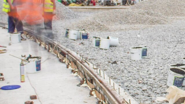 Workers install new tram rails on concrete plates during a reconstruction of the route timelapse. Filling by liquid resin for reduction of vibration and noice. Modernizations of tram tracks