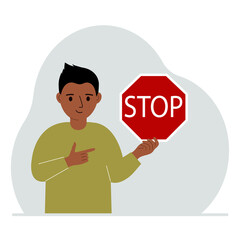 Little boy holding a red stop sign in her hand.