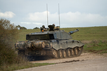 detailed close up of a commander and gunner directing action in a British army FV4034 Challenger 2 ii main battle tank on a military combat exercise, Wiltshire UK