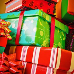 Stacked red and green Christmas gifts.Square background, colorful holiday gift boxes with ribbons and bows.